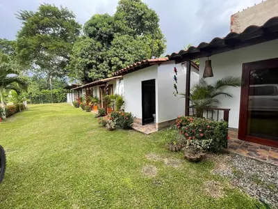 a house with a yard next to a building at Villa with pool, jacuzzi, Turkish bath, BBQ, kiosk, and green area in Sopetran