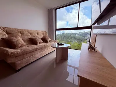 a living room with a couch and a table at Nuevo apartamento moderno, espectacular vista in Manizales