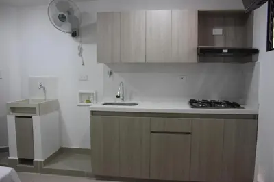 a small kitchen with a sink and a stove at Apartahotel Ces in Medellín