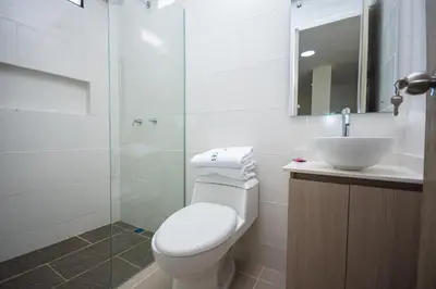 a bathroom with a toilet and a sink and a shower at Apartahotel Ces in Medellín
