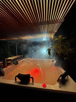 a bath tub with red water in it with a light at Casa Moderna en el Bosque Jacuzzi y Deck Privado in Mazo