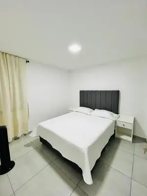 a bedroom with a white bed and a television at Central apartment in Bello in Bello