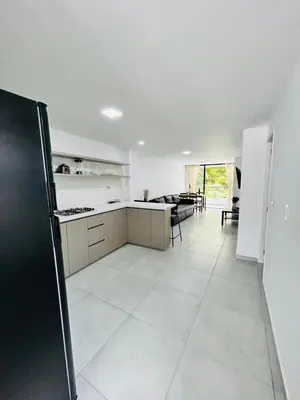 a kitchen with a black refrigerator in a room at Central apartment in Bello in Bello