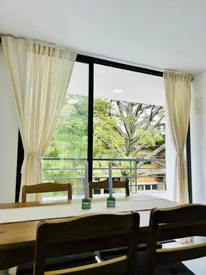 a dining room with a table and a large window at Central apartment in Bello in Bello