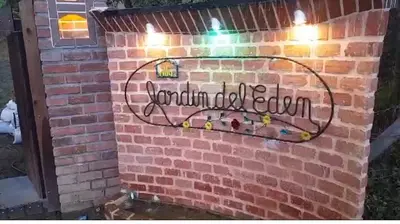 a brick wall with a sign that reads grandma of bloom at Ranch Style Home Jardin Del Eden in Verdún