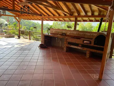 a patio with a wooden roof and a bench at Ranch Style Home Jardin Del Eden in Verdún