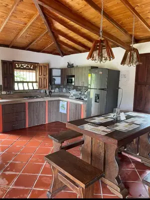 a large kitchen with a table and a refrigerator at Ranch Style Home Jardin Del Eden in Verdún