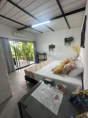 a bedroom with a bed and a table with glasses on it at Cabañas Flor Del Monte in Sopetran