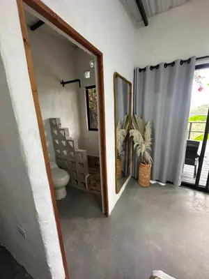 a bathroom with a toilet and a mirror at Cabañas Flor Del Monte in Sopetran