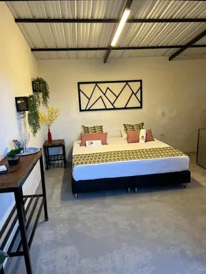 a bedroom with a large bed in a room at Cabañas Flor Del Monte in Sopetran