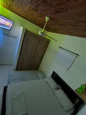 a bedroom with a bed and a ceiling fan at Hospedaje LunaDorada en Doradal in Puerto Triunfo