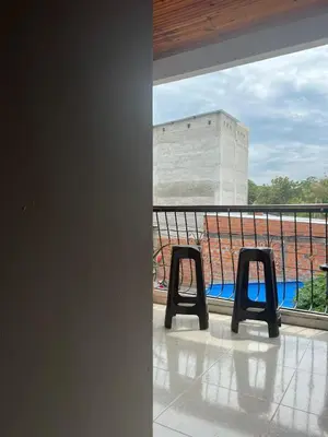 a room with two chairs on a balcony at Hospedaje LunaDorada en Doradal in Puerto Triunfo