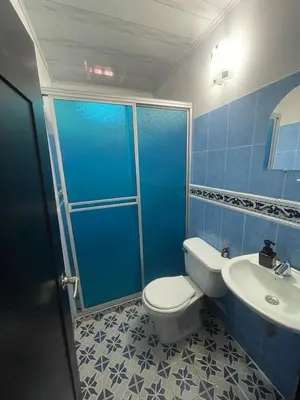 a blue bathroom with a toilet and a sink at Hospedaje LunaDorada en Doradal in Puerto Triunfo