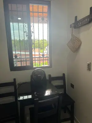 a room with a table and chairs and a window at Hospedaje LunaDorada en Doradal in Puerto Triunfo