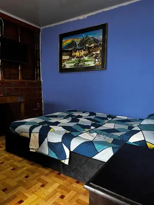 a bedroom with a bed and a picture on the wall at piedras del ocaso manizales in Manizales