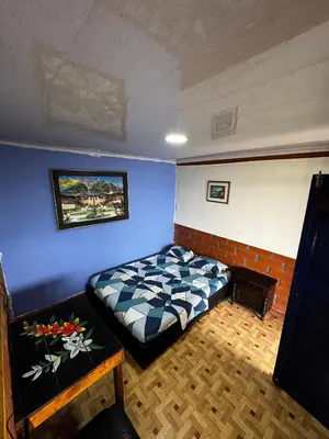 a bedroom with a bed and a blue wall at piedras del ocaso manizales in Manizales