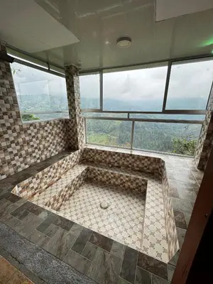 a large bath tub in a room with windows at piedras del ocaso manizales in Manizales