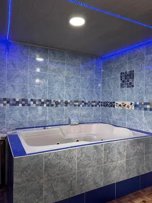 a bath tub in a bathroom with blue lights at piedras del ocaso manizales in Manizales