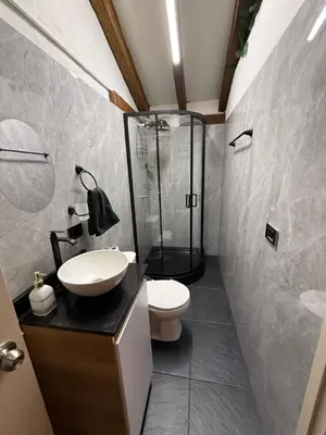 a bathroom with a shower and a toilet and a sink at Apartamento tipo loft in Guarne