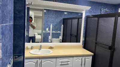 a man taking a picture of a bathroom mirror at Casa Primaveral Espaciosa Cerca al Estadio in Medellín
