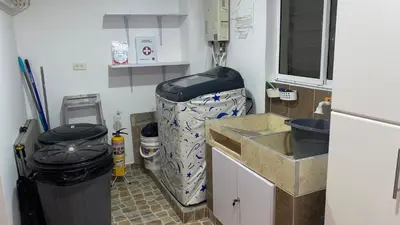 a small kitchen with a sink and a trash can at Casa Primaveral Espaciosa Cerca al Estadio in Medellín