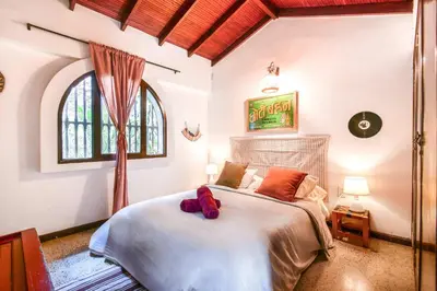 a bedroom with a large bed in a room at Bright Colonial 5BR House with Balcony in Medellín