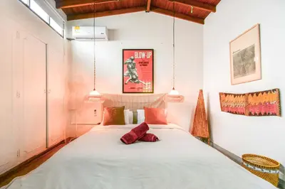 a bedroom with a large bed in a room at Bright Colonial 5BR House with Balcony in Medellín