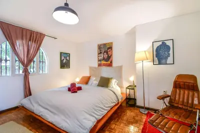 a bedroom with a bed with a teddy bear on it at Bright Colonial 5BR House with Balcony in Medellín