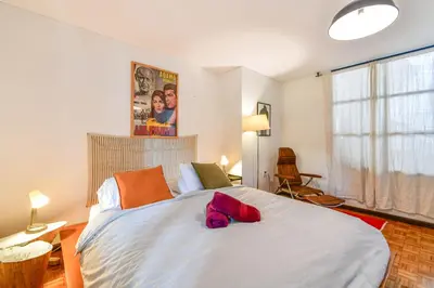 a bedroom with a large white bed and a window at Bright Colonial 5BR House with Balcony in Medellín