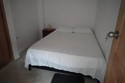 a small bedroom with a white bed in a room at Apartamento Exclusivo con vista panorámica in Medellín