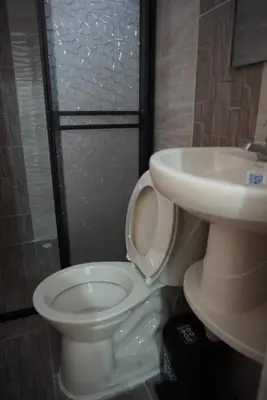 a bathroom with a toilet and a sink at Apartamento Exclusivo con vista panorámica in Medellín