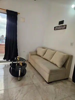a living room with a couch and a table at Apartamento Exclusivo con vista panorámica in Medellín
