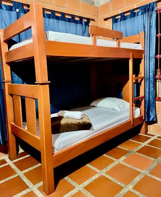 two bunk beds in a room with at Finca La Carmelita Casa Campestre con Piscina y entre Montañas a sólo minutos de Santa Rosa de Cabal in Santa Rosa de Cabal