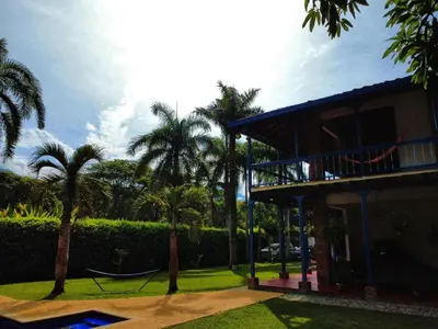a house with palm trees and a hammock in a yard at San José del refugio in Jericó