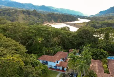 an aerial view of a house next to a river at San José del refugio in Jericó