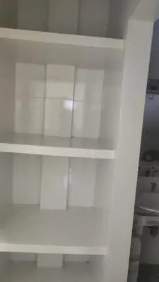 a white book shelf in a room at Hostal Manantiales La Esperanza in Cocorná