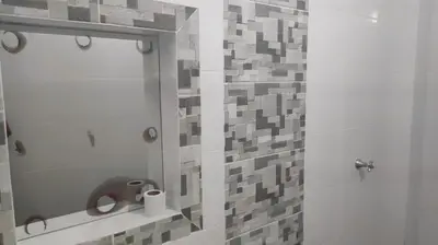 a bathroom with a shower with a toilet and a mirror at Hostal Manantiales La Esperanza in Cocorná