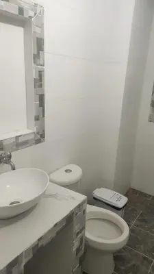 a white bathroom with a sink and a toilet at Hostal Manantiales La Esperanza in Cocorná