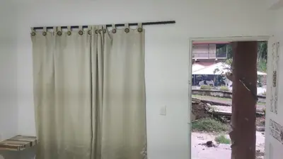 a shower curtain in a room with a window at Hostal Manantiales La Esperanza in Cocorná