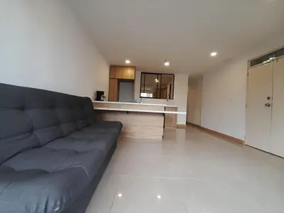 a living room with a couch and a kitchen at MEDELLIN ALOJAMIENTO EN Laureles in Medellín