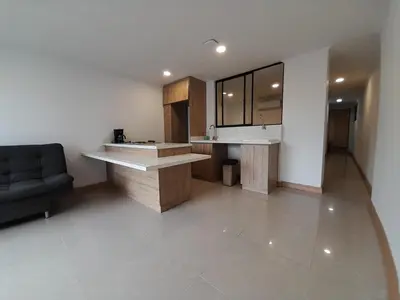 a kitchen with a counter and a couch in a room at MEDELLIN ALOJAMIENTO EN Laureles in Medellín