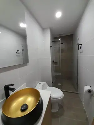 a bathroom with a gold sink and a toilet at MEDELLIN ALOJAMIENTO EN Laureles in Medellín