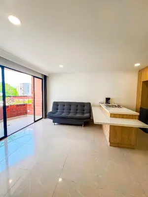 a living room with a couch and a table at MEDELLIN ALOJAMIENTO EN Laureles in Medellín