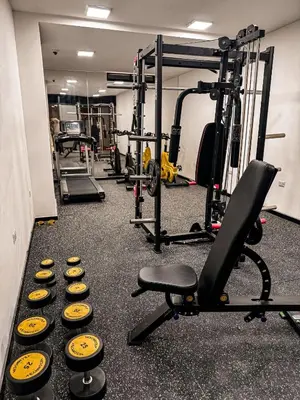 a gym with several dumbbells and a row of weights at Torre U kooliving in Manizales
