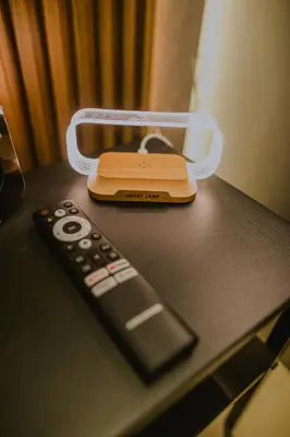 a remote control sitting on a table next to a plastic holder at Torre U kooliving in Manizales