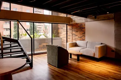 a living room with a couch and a table at Uukam by Bernalo Hotels in Medellín