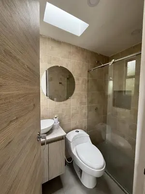 a bathroom with a toilet and a sink and a shower at Casa Campestre con Piscina in Manizales