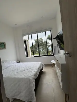 a bedroom with a bed and a window at Casa Campestre con Piscina in Manizales