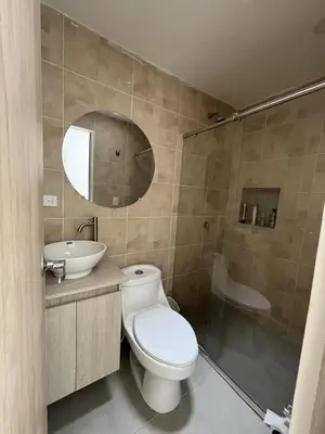 a bathroom with a toilet and a sink and a shower at Casa Campestre con Piscina in Manizales