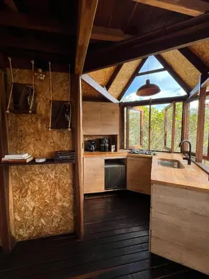 a kitchen with wooden counters and a large window at Ikuna Luxury Glamping 1h from Medellin with Private Jacuzzi in San Vicente